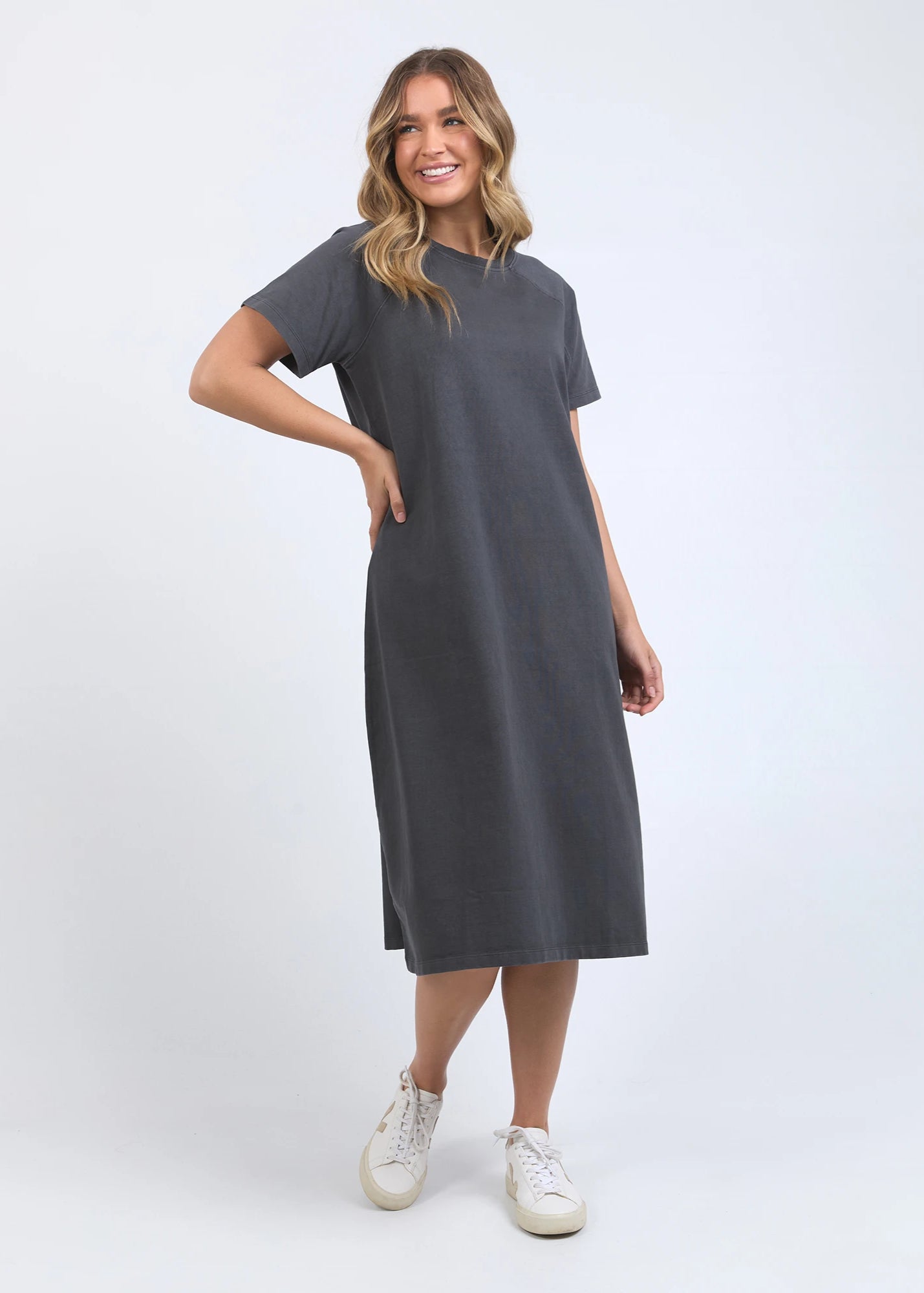 Woman wearing a gray dress on a white background