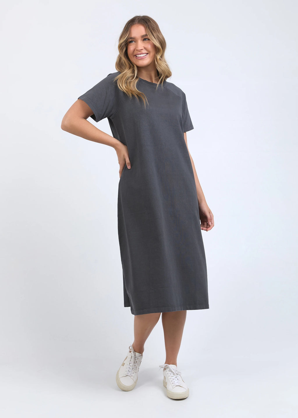 Woman wearing a gray dress on a white background